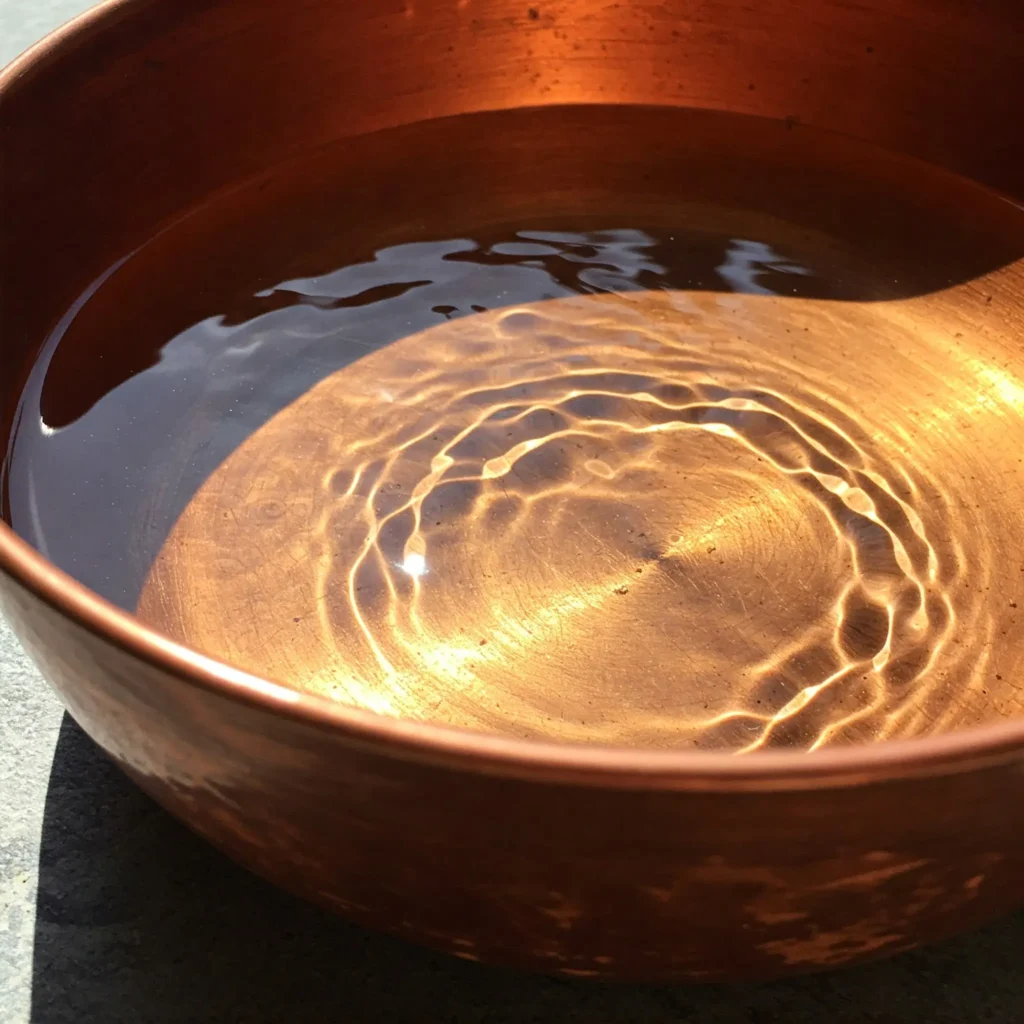 A copper bowl of water