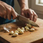 Someone cutting garlic